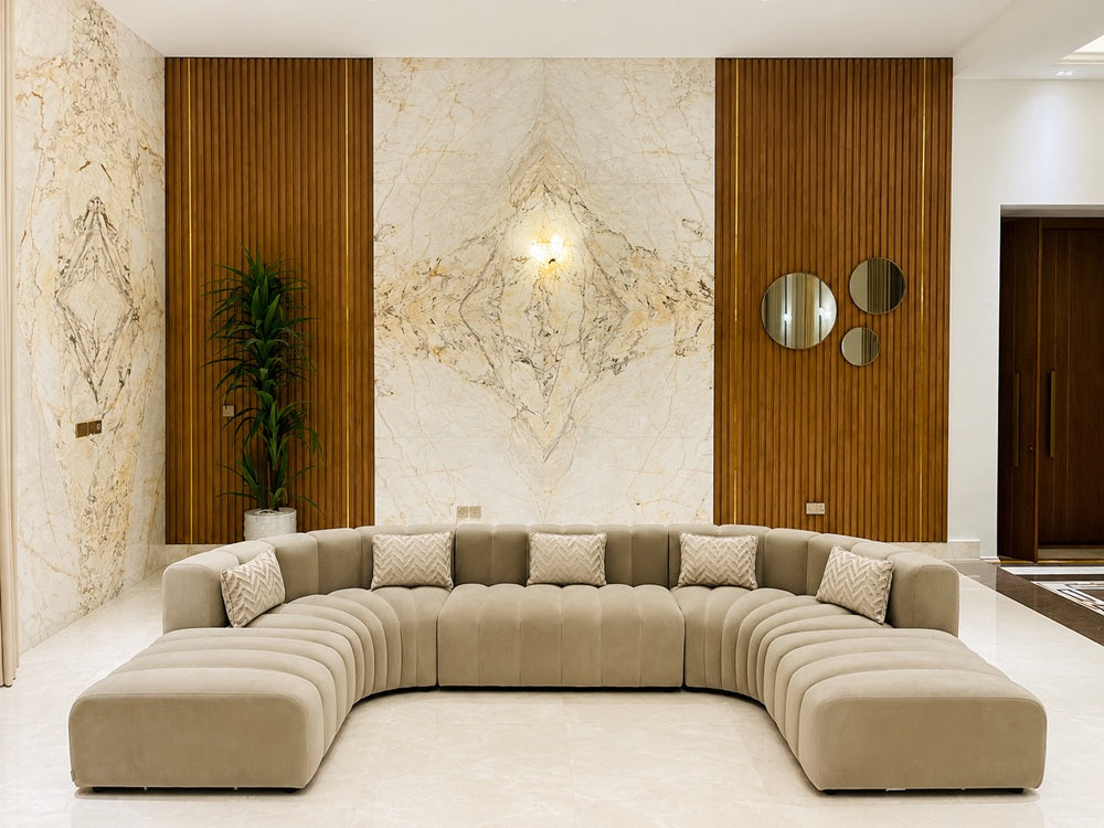 Luxurious Cosmo Concave sofa elegantly anchoring a modern marble and wood-paneled living room.