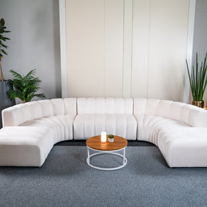 Vanilla White Cosmo modular table paired with a sculptural sofa for event lounge setup.